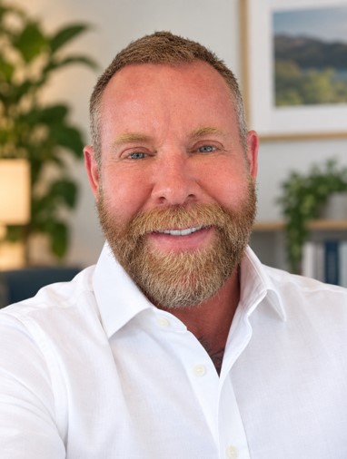 Mark Hardy, psychosynthesis counsellor, smiling in his therapy room